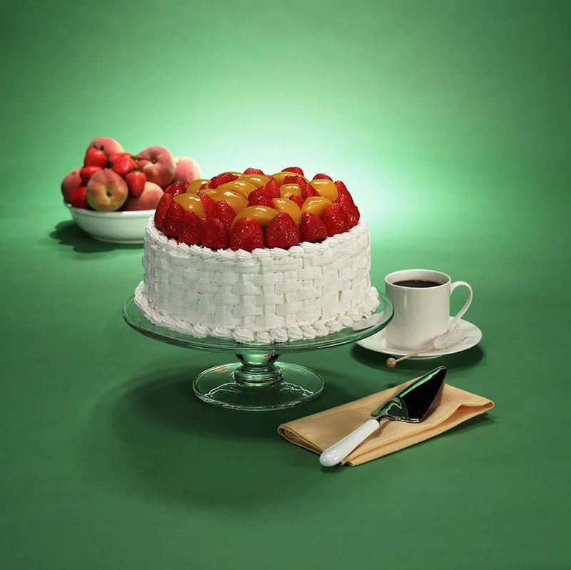 Fruit-topped cake on a glass stand