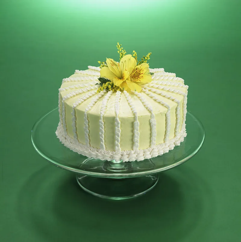 Pale yellow decorated cake with flowers