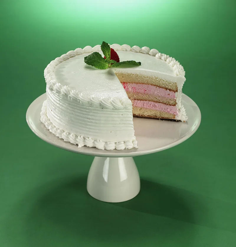 A sliced layer cake with pale pink filling