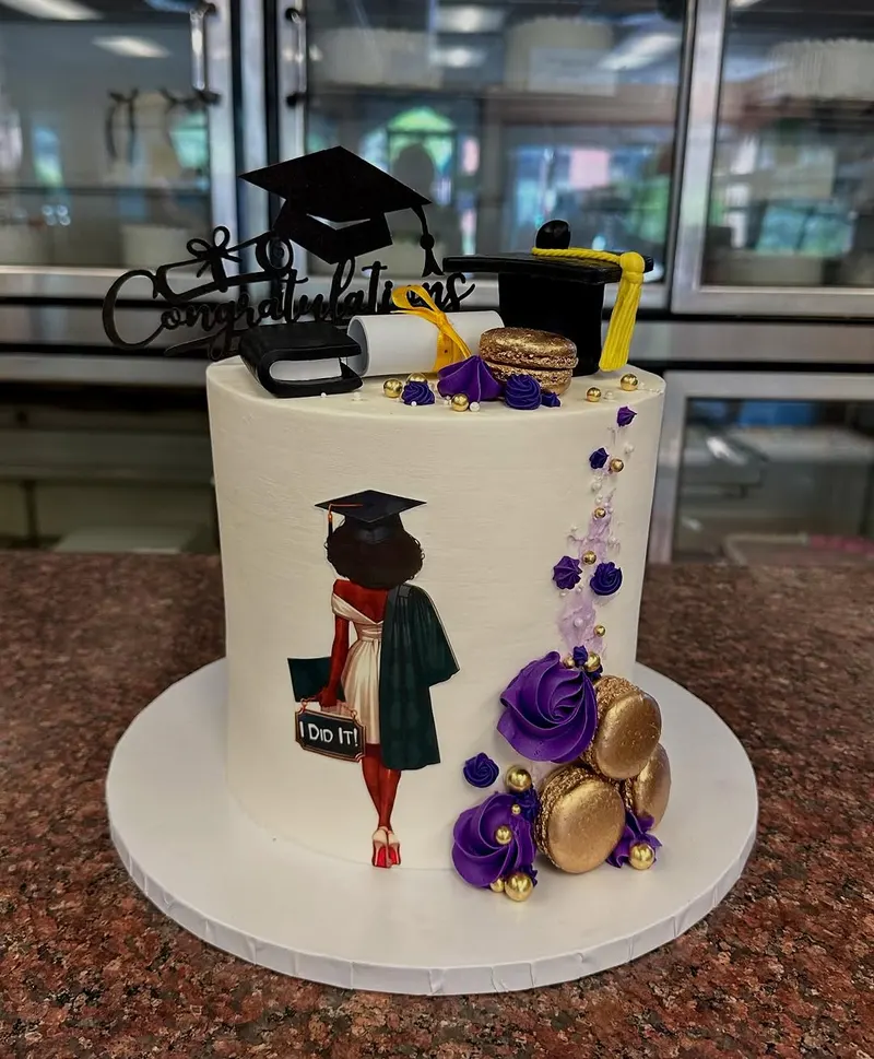 Graduation cake with gold macarons and purple rosettes